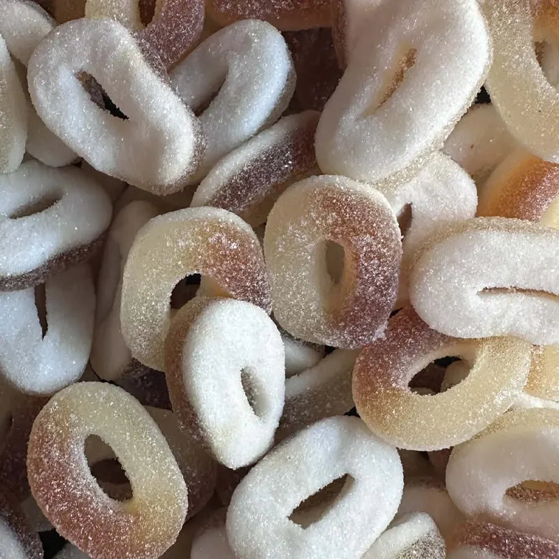 Assorted sugary donut-shaped candies in a pile
