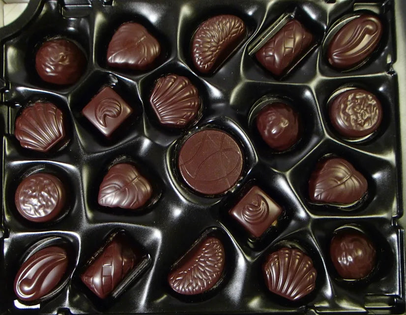 Assorted chocolate candies in a black box