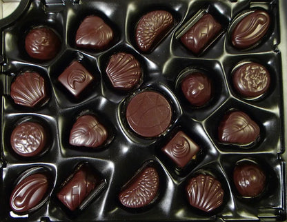Assorted chocolate candies in a black box
